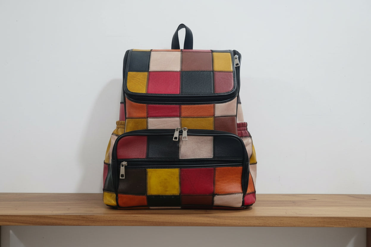 Colorful patchwork backpack on a bed