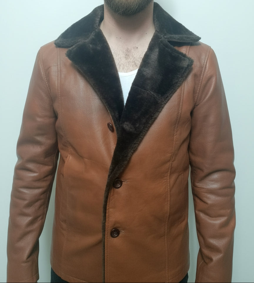 Brown leather jacket with fur collar worn by a person against a plain background