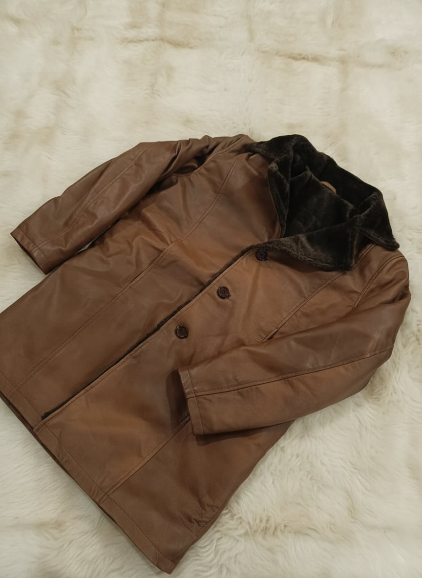 Brown jacket with black lining on a beige textured surface