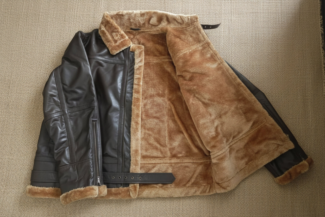 Brown leather jacket with fur lining on a wooden floor