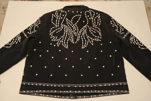 Black jacket with white floral patterns and bead embellishments on a white background