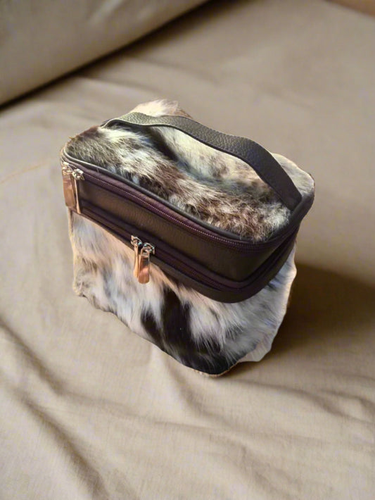 a leather makeup pouch kept on a beige color fabric