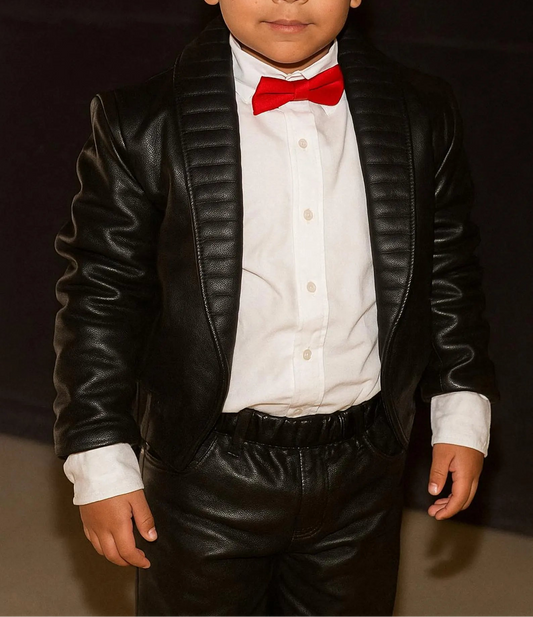 Child wearing a black MJ Billie jean outfitleather suit with a red bow tie against a dark background 