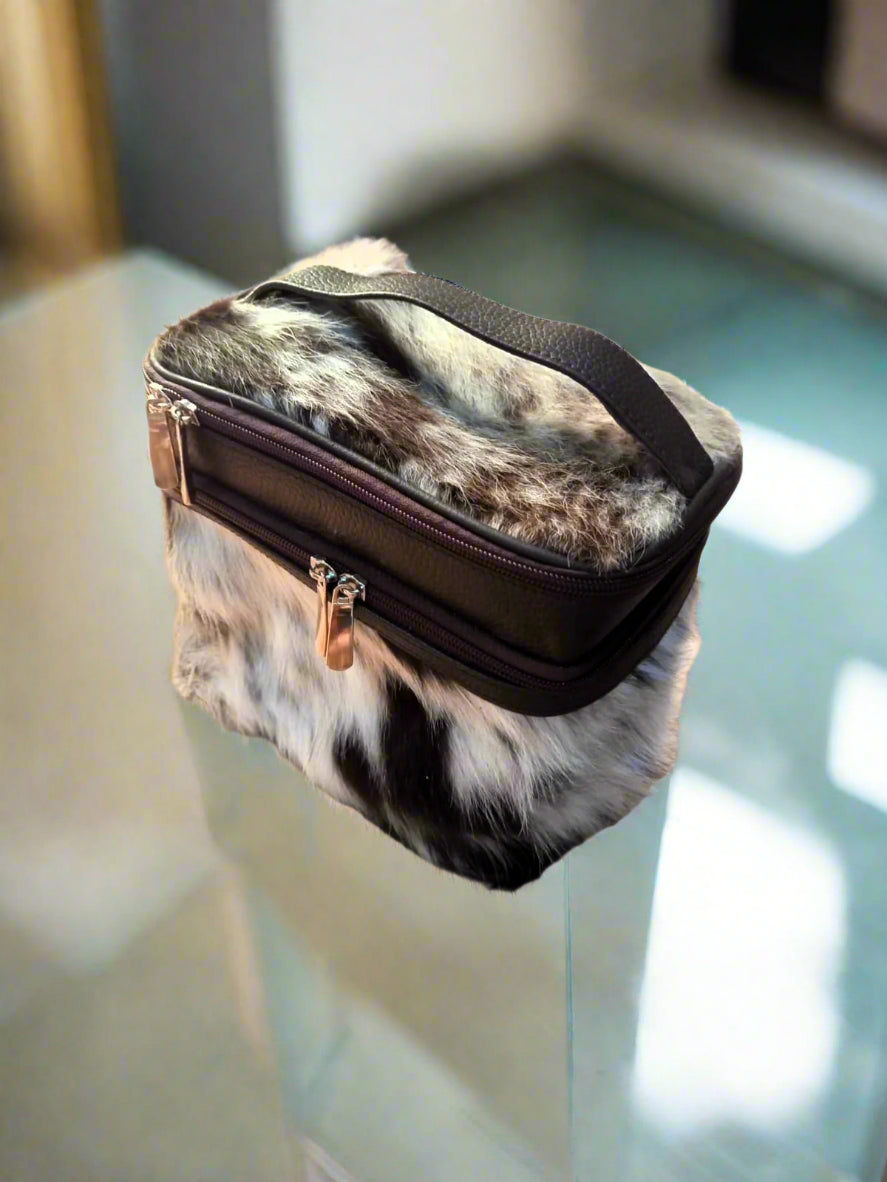 Makeup bag with fur pattern on a clear glass surface barow makeup bag