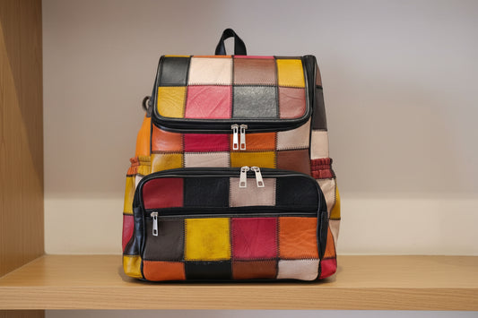 Colorful patchwork backpack and handbag on a table with a wooden background